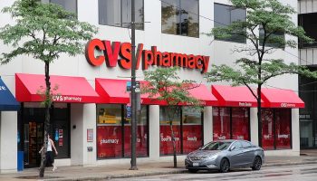 CLEVELAND, USA - JUNE 29, 2013: People walk by CVS Pharmacy in Cleveland. CVS is the 2nd largest pharmacy retailer in the USA with 7,600 locations.